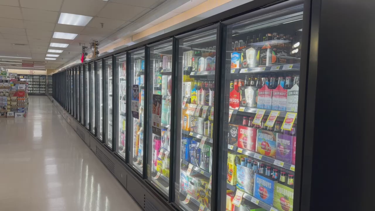 a video of black glass door coolers in a grocery store filled with beverages and beer